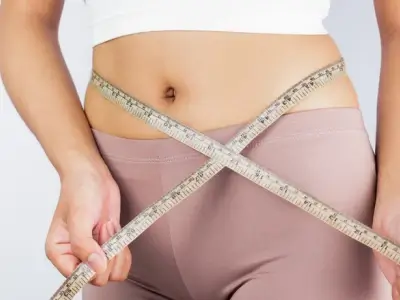measuring tape showing waist and hip measurements for underwear sizing