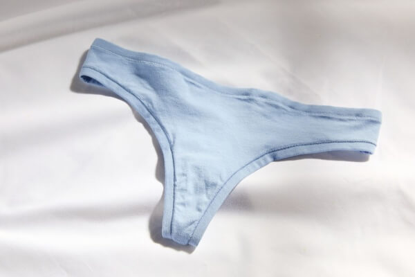 A stylish flat lay of several comfortable thongs in soft fabrics like modal and cotton.